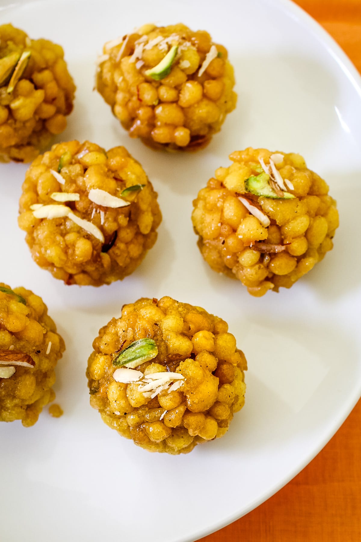 Couple of round boondi ladoos on a white plate